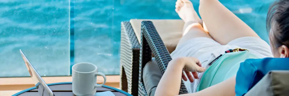 Femme profitant du balcon de sa cabine pour prendre un bain de soleil